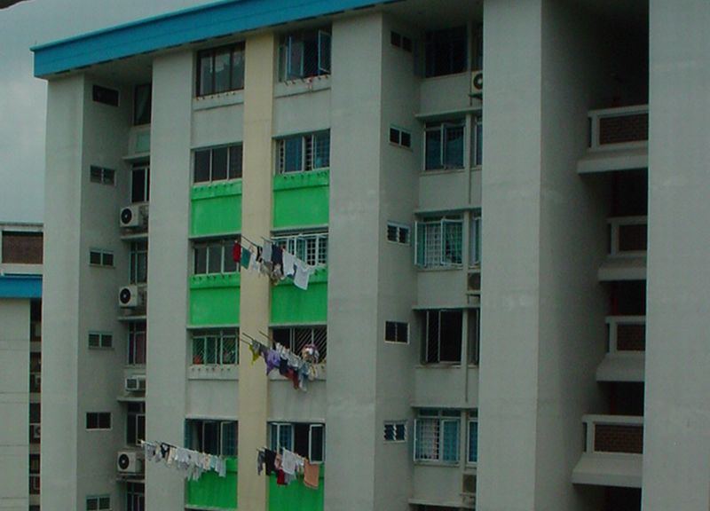 Laundry on bamboo poles outside HDB blocks in Hougang.